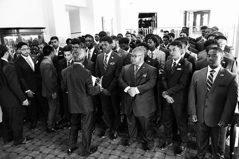 A group of MBK young men standing together in solidarity with program leaders